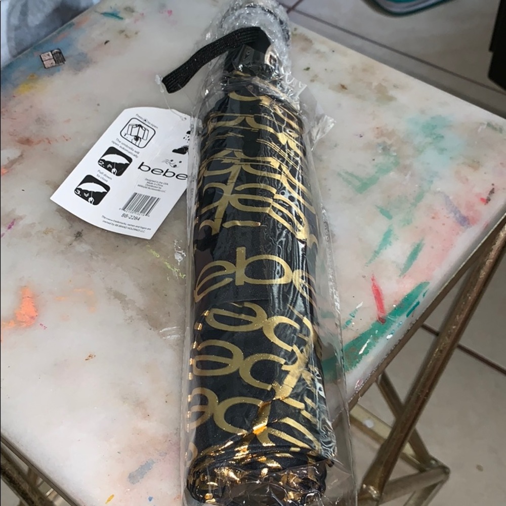Bebe umbrella logo in gold printed all over sealed